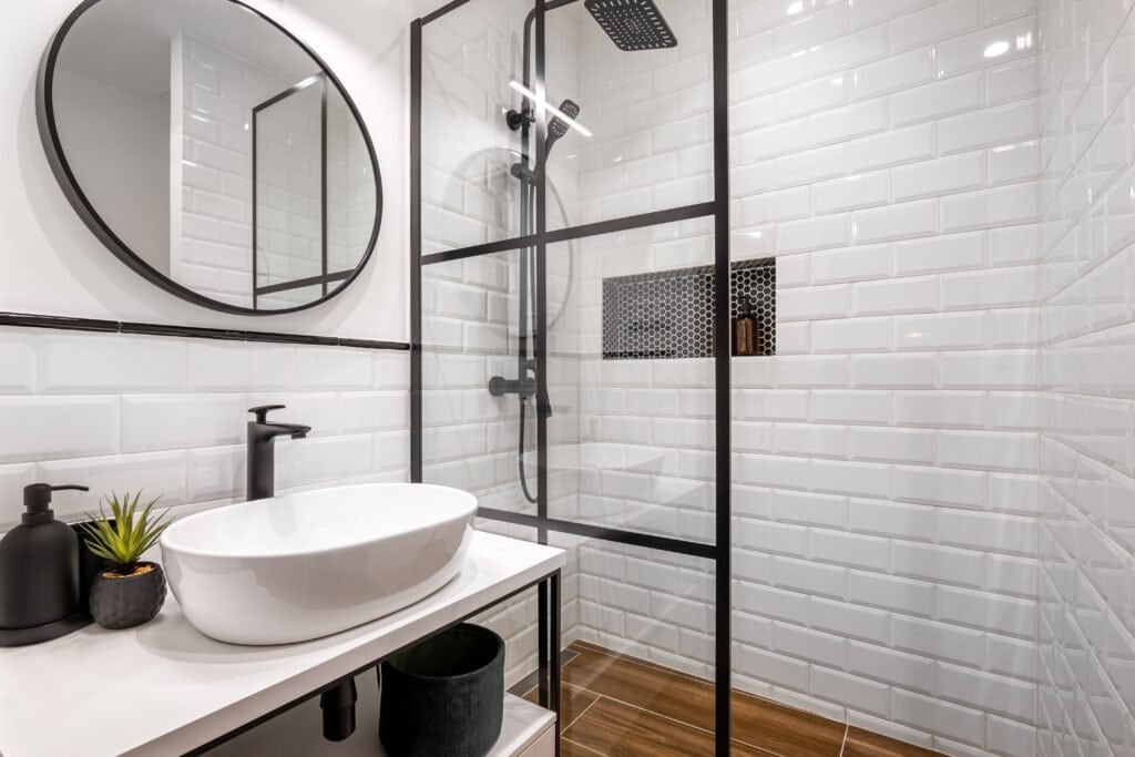 small modern bathroom with shower and white tiles